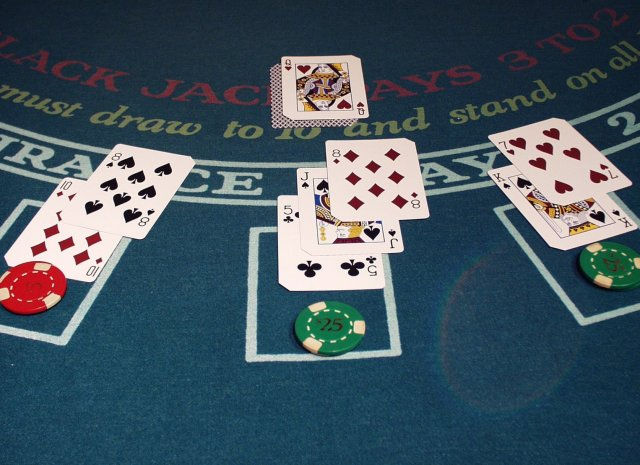 この状況ではディーラーの伏せてあるカードがまだ開かれていないのでディーラーの最終的な手（合計の数字）は確定していないが、この段階で中央のプレーヤーは負けが確定し賭け金は回収されてしまう。