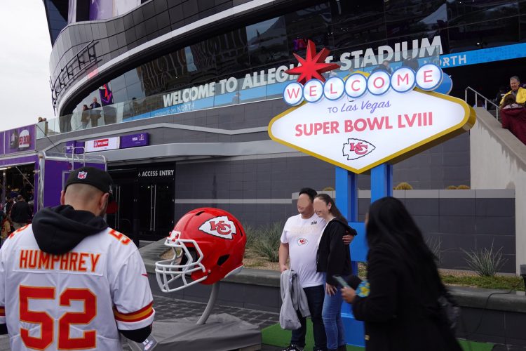 2024年のスーパーボウルの開催地ラスベガスの Allegiant Stadium の前で記念撮影をするカンザスシティー・チーフスのファン。(2024年2月5日)